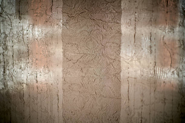 Old wallpaper on the wall. Old wallpaper for texture or background.