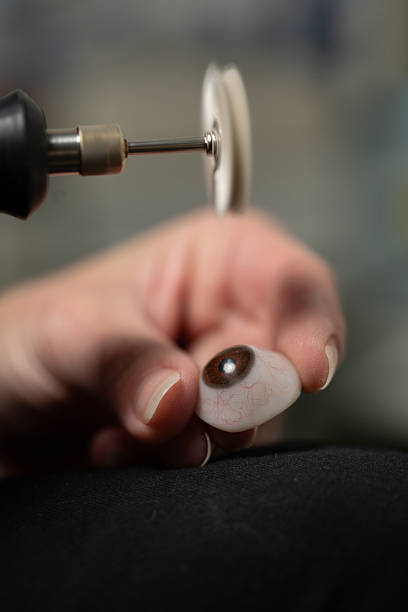 istock Ocularist polishing prosthetic eye with rotary tool 2206732955