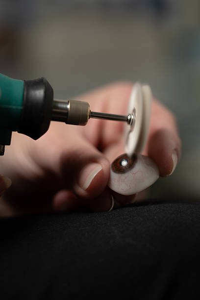 istock Ocularist polishing prosthetic eye with rotary tool 2206732965