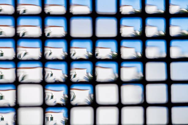 Blurry reflection of a house seen through water drops, creating an abstract view.
