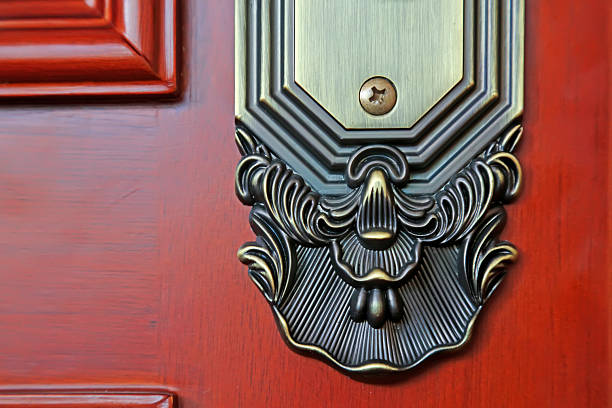 Close up of silver door handle on wooden door. Concept of interior details.
