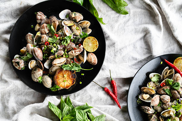 istock Fresh seafood dish featuring clams and mussels with garlic, herbs, and chili on a rustic table 2206747313