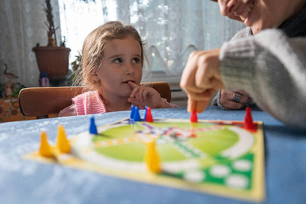 istock Child Development. Family Plays Board Game at Home 2206747369
