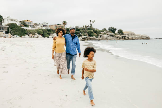 istock Barefoot on the soft sand, this family enjoys a tranquil coastal escape. 2206748005