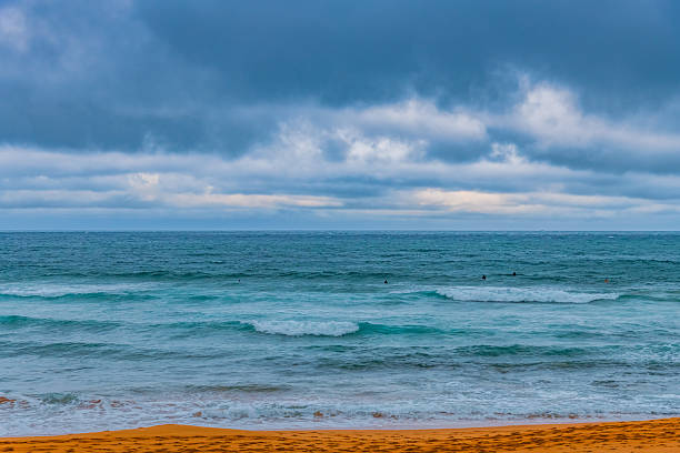 Overcast Sunrise Seascape with rocks and waves at Avalon on the Northern Beaches of Sydney, NSW, Australia.