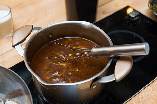 istock Whisk stirring sauce in stainless steel pot. 2206752153