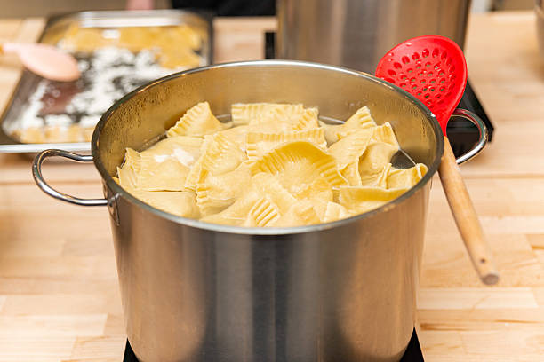 istock Fresh homemade ravioli boiling in large pot. 2206752259
