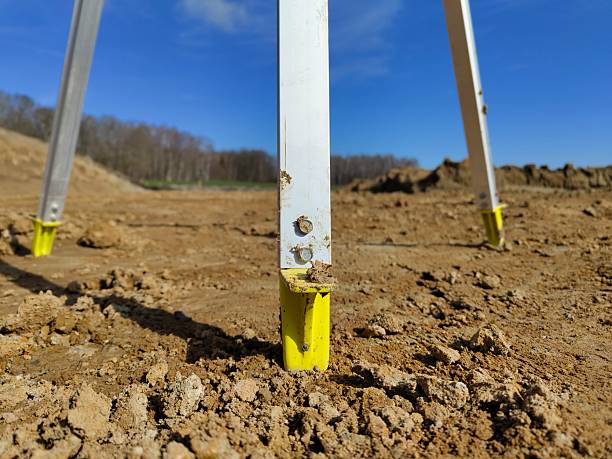 istock Surveying tripod on construction site with blue sky background 2206757496