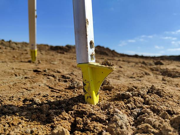 istock Close-up of construction stakes in sandy soil under clear blue sky 2206757502