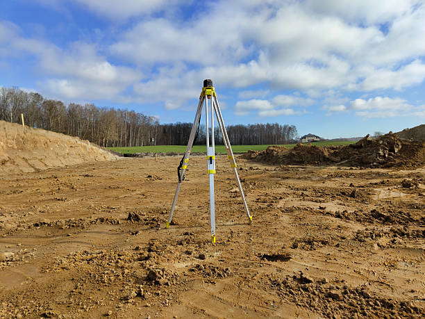 istock Tripod setup on construction site with cloudy sky and dirt landscape 2206757521