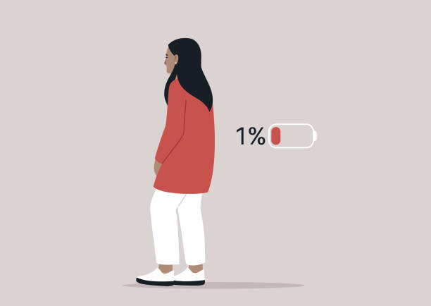 istock A woman stands with a slouched posture, expressing her exhaustion as she feels a disconnect from her surroundings, The low battery indicator emphasizes her fatigue 2206757897