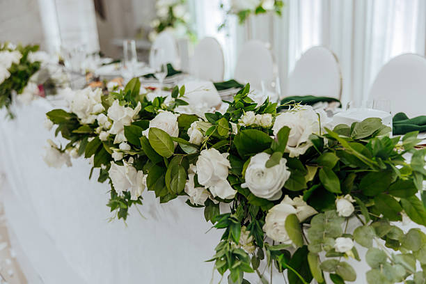 istock A table with white flowers and green leaves 2206757929