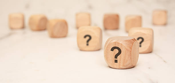 istock wooden blocks with question marks on a marble surface, symbolizing uncertainty and curiosity 2206758126