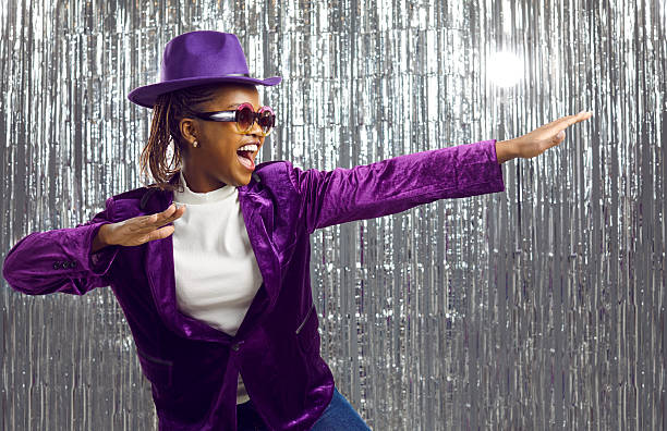 istock Smiling young black woman dancing on glitter background 2206759661
