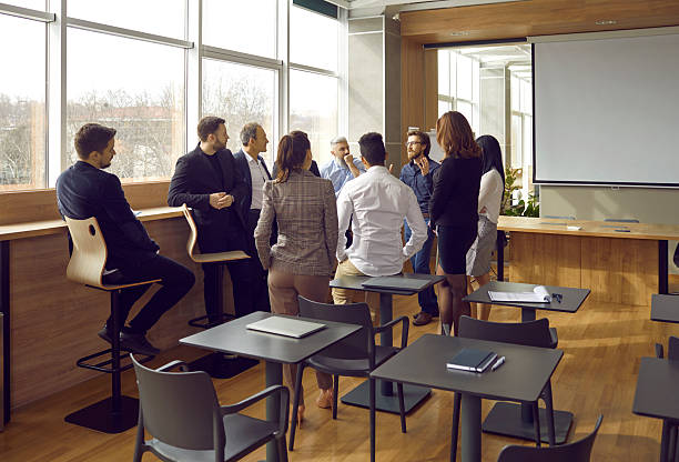 istock Business coach has conversation with group of people after training, lecture or seminar in office. 2206760006