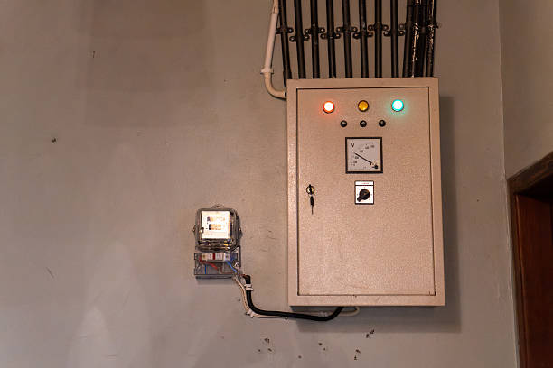 Electrical panel with meter and conduit displays power management controls in an indoor setting Use for home improvement or facility management visuals.