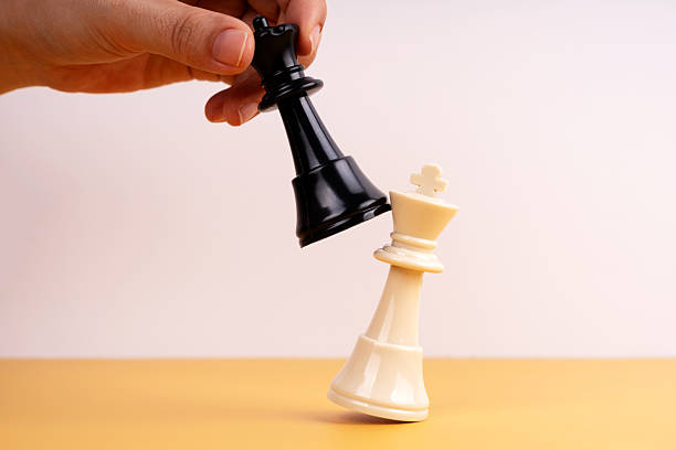 istock Checkmate concept. Hand of an unrecognizable man playing chess defeating his opponent's king 2206768907