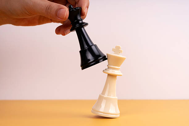 istock Checkmate concept. Hand of an unrecognizable man playing chess defeating his opponent's king 2206768911