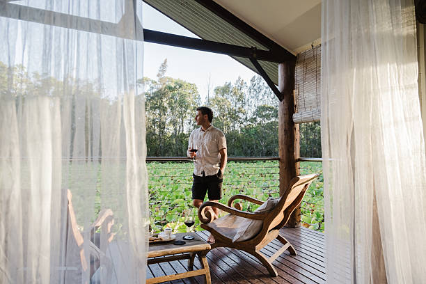 istock Man Relaxing in lake house villa 2206770631