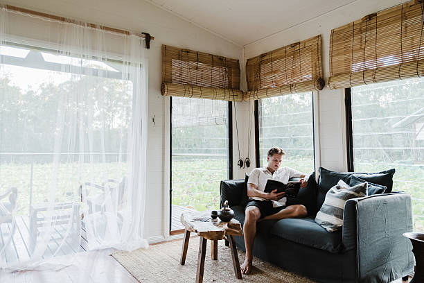 istock Man Relaxing in lake house villa 2206770669