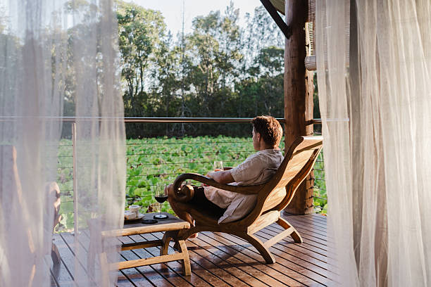 istock Man Relaxing in lake house villa 2206770752
