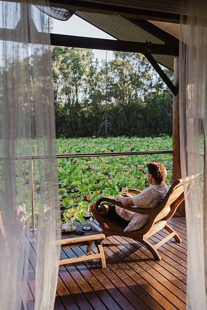 istock Man Relaxing in lake house villa 2206770755