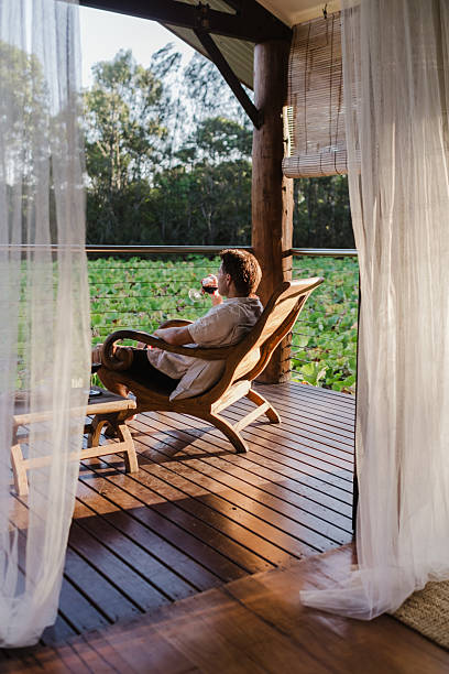 istock Man Relaxing in lake house villa 2206770763