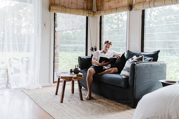 istock Man Relaxing in lake house villa 2206770847