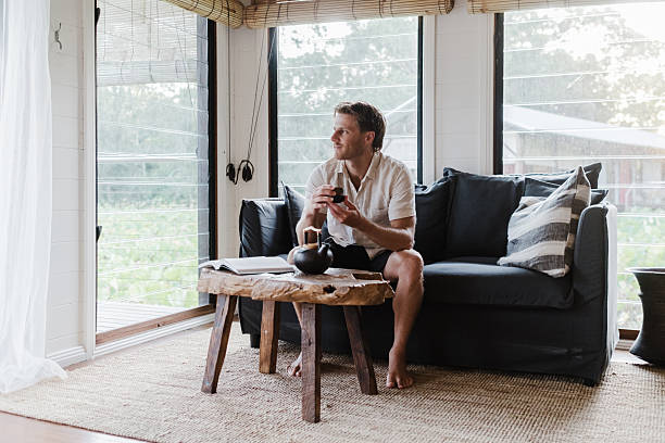 istock Man Relaxing in lake house villa 2206770853