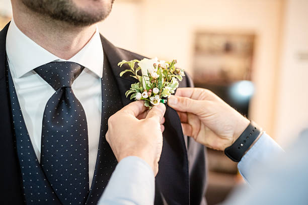 istock Groom gets boutonniere before ceremony 2206774520