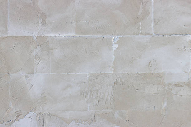 istock A wall made of white bricks with a rough texture 2206783166