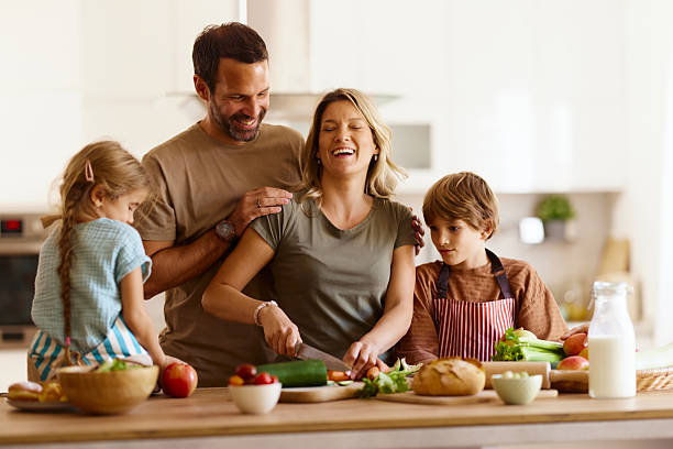 istock Happy family enjoying while preparing healthy meal in the kitchen. 2206786285