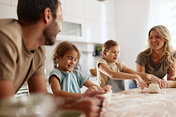 istock Happy family making a cake together at home. 2206786304