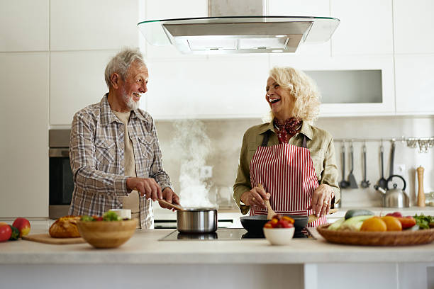 istock Cheerful senior couple having fun while cooking in the kitchen. 2206786685