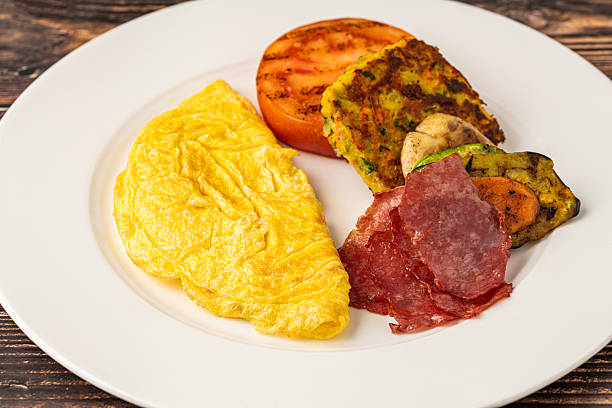 istock Rustic breakfast plate with fried eggs, grilled vegetables, and turkey bacon 2206786885
