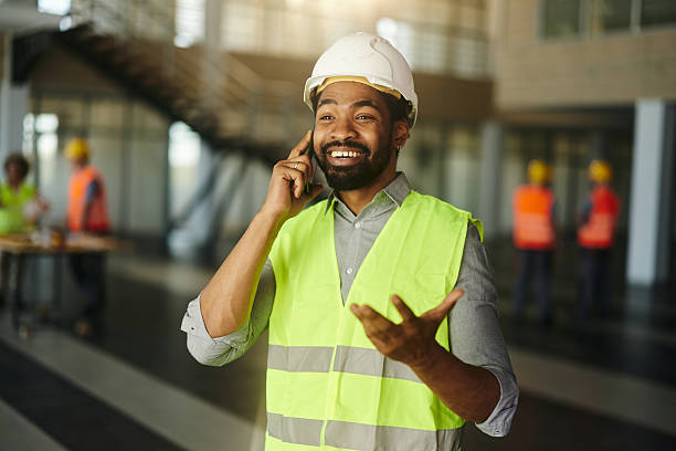 istock Happy black engineer talking to someone over mobile phone. 2206786968