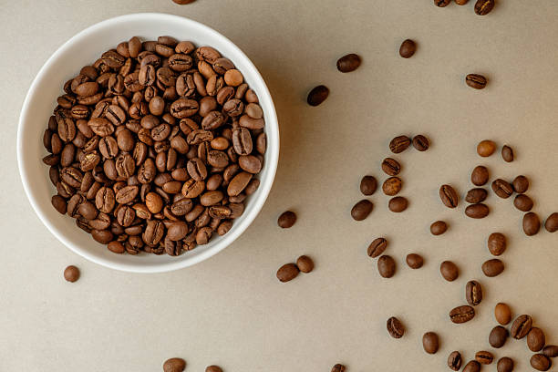 istock Rich roasted coffee beans spread across a soft surface in natural light 2206787047