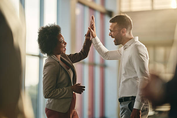 istock Cheerful entrepreneurs giving each other high-five in the office. 2206787604