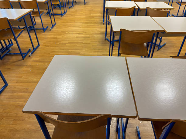 istock Empty School Classroom with Neatly Arranged Desks and Chairs 2206787996