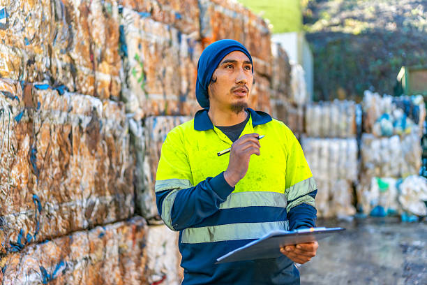 istock Man doing inventory at recycling plant area with plastic bales 2206788038