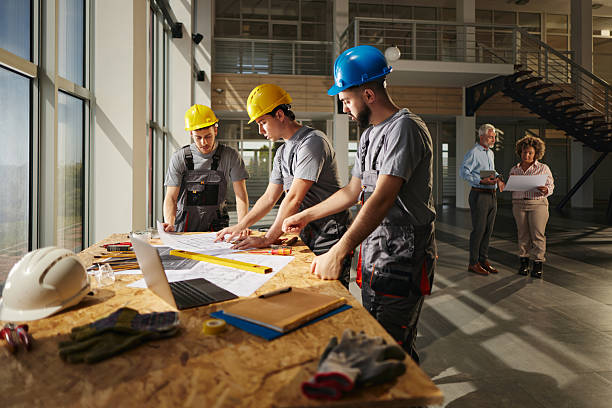 istock Team of manual workers working on blueprints in construction building. 2206788085