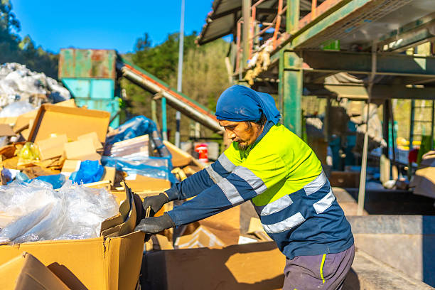istock Man separating materials outside a recycling plant 2206788117