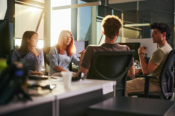 istock Team of young designers talking on a break in the office. 2206789673