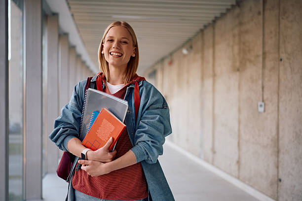 istock Happy female college student at campus looking at camera. 2206790660