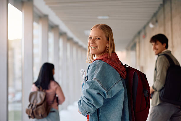 istock Happy college student going on a lecture with her friends and looking at camera. 2206790742