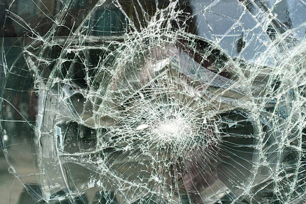 istock Broken glass with a spiderweb crack pattern, appearing to have been struck at the center. 2206791605