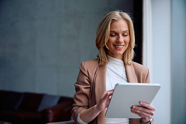istock Happy female entrepreneur using touchpad while working in the office. 2206793112