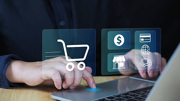 istock Businessman using lap top computer with virtual trolley shopping cart to order for online shopping and e-commerce technology 2206793325