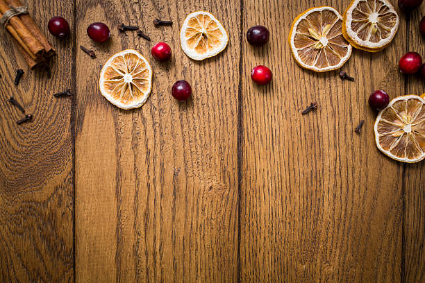 istock Dried citrus slices, cranberries, and spices arranged on a wooden surface, creating an inviting autumnal display for seasonal decor 2206793332