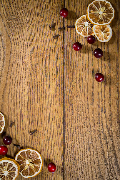 istock Dried citrus and cranberries arranged on a rustic wooden surface for a festive decoration idea in autumn or winter 2206793365